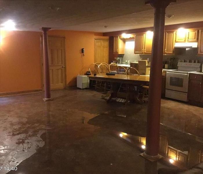 Big Water puddle across brown kitchen floor